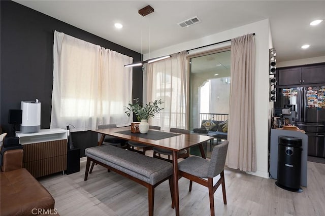 dining space with recessed lighting, visible vents, radiator heating unit, and light wood finished floors