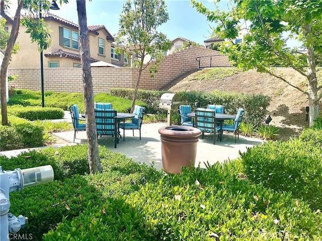 view of patio with outdoor dining space and fence