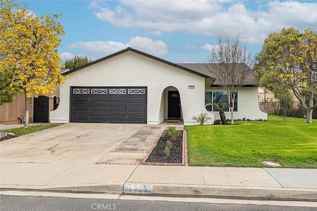 ranch-style house with a front lawn, fence, stucco siding, a garage, and driveway