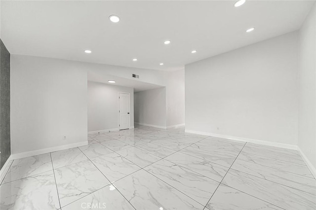 spare room featuring recessed lighting, visible vents, baseboards, and marble finish floor