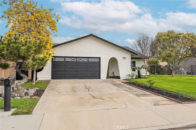 ranch-style house with a garage, stucco siding, concrete driveway, and a front lawn