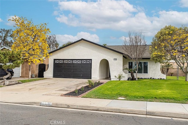 ranch-style home with a front lawn, fence, concrete driveway, stucco siding, and a garage