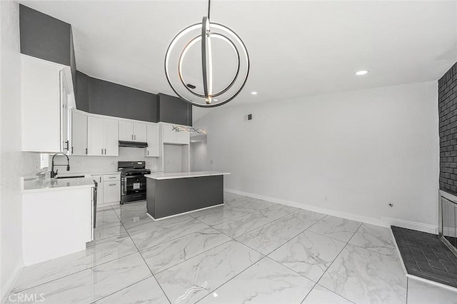 kitchen with a center island, white cabinets, black range, marble finish floor, and a sink