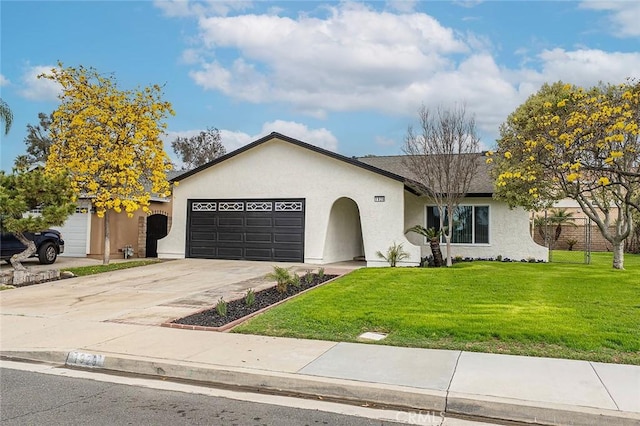 ranch-style home featuring stucco siding, an attached garage, concrete driveway, and a front lawn