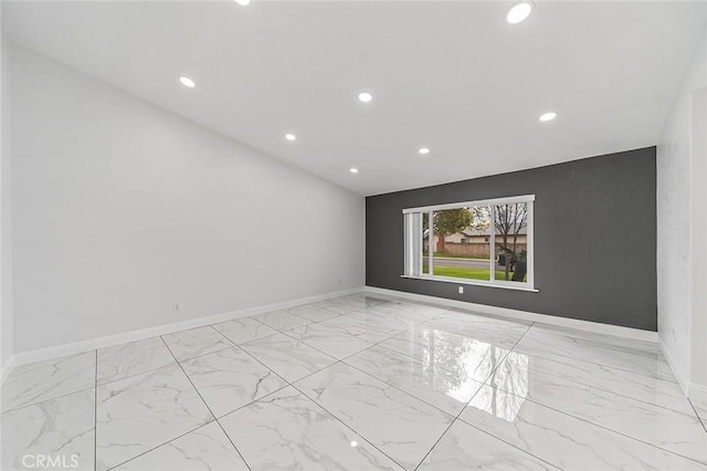 empty room featuring baseboards and marble finish floor