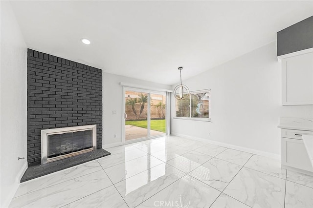 unfurnished living room with lofted ceiling, marble finish floor, recessed lighting, baseboards, and a brick fireplace