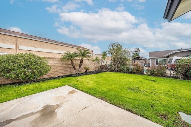 view of yard with a patio and fence