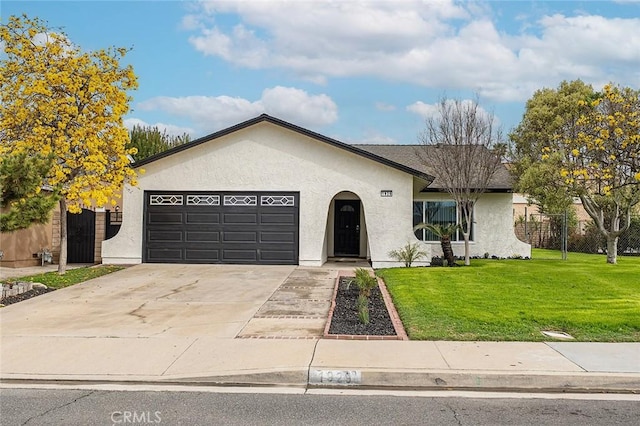 ranch-style house with a front lawn, fence, stucco siding, a garage, and driveway