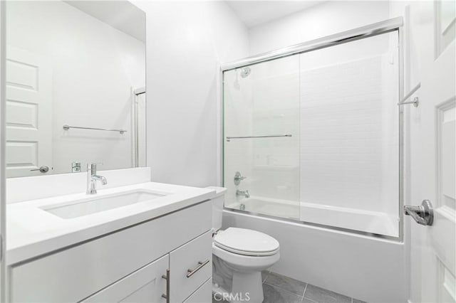 bathroom featuring vanity, toilet, tile patterned flooring, and shower / bath combination with glass door