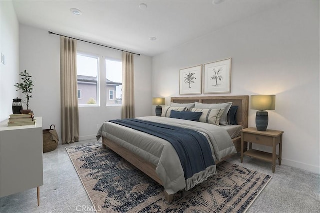 bedroom with baseboards and light colored carpet