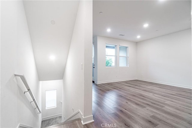 staircase with visible vents, recessed lighting, baseboards, and wood finished floors