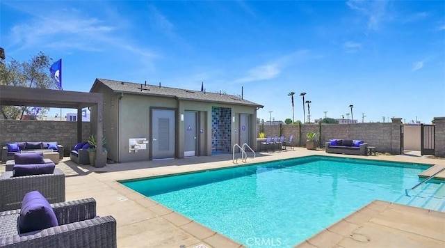 community pool with a patio, fence, and an outdoor hangout area