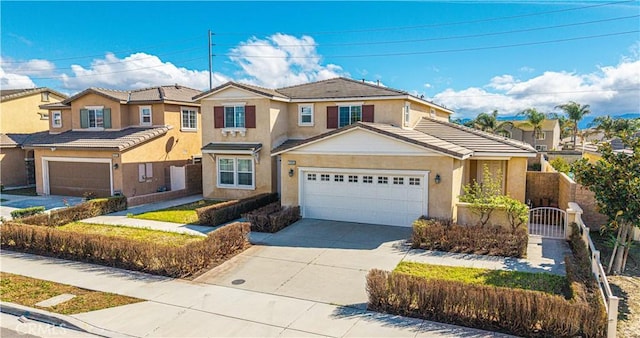 traditional home featuring a gate, fence, driveway, stucco siding, and a tiled roof