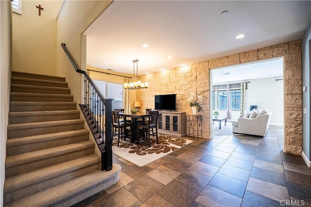 living room with stairs, a notable chandelier, and recessed lighting