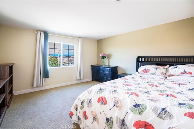 bedroom featuring baseboards and carpet