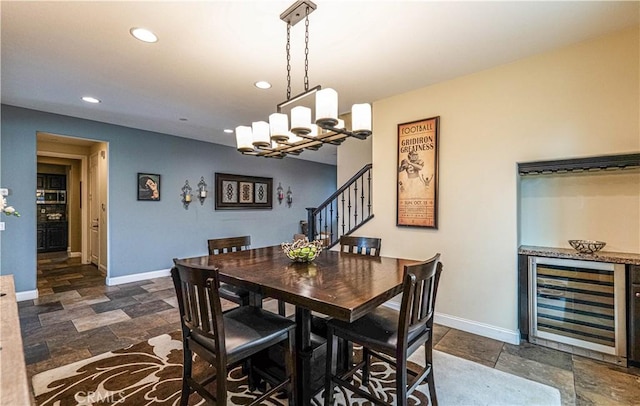 dining space with stairway, beverage cooler, baseboards, recessed lighting, and stone finish flooring