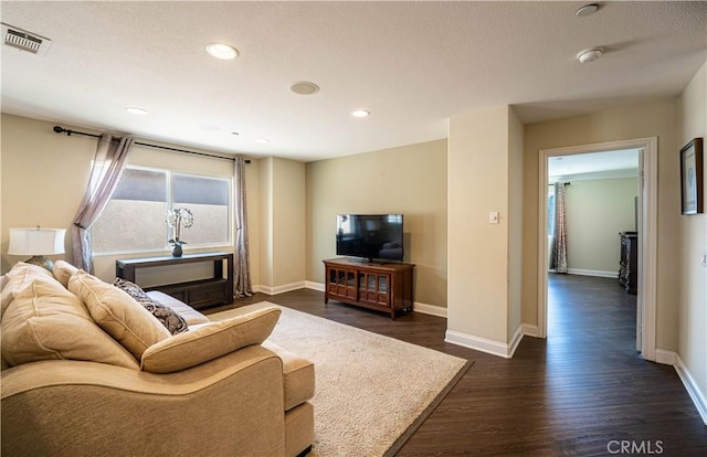 living area with dark wood-type flooring, recessed lighting, baseboards, and visible vents