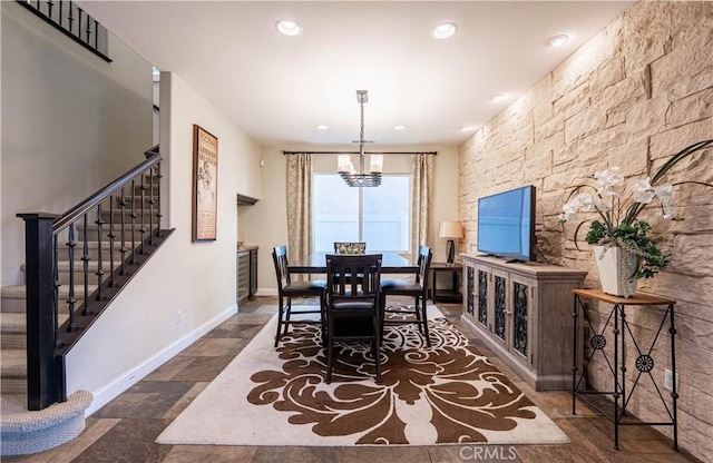 dining area with stairway, baseboards, recessed lighting, stone tile flooring, and a chandelier