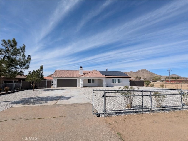 single story home featuring a fenced front yard, a garage, driveway, and a tiled roof