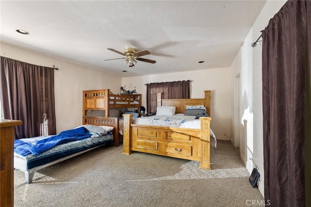 bedroom with light carpet, baseboards, and a ceiling fan