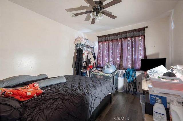 bedroom with wood finished floors and a ceiling fan