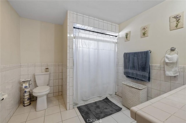 bathroom with tile patterned flooring, tile walls, toilet, and a shower with curtain