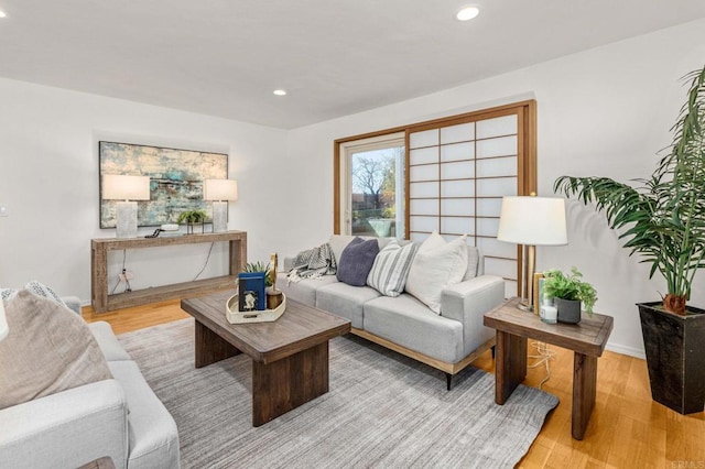 living room with recessed lighting and light wood-type flooring