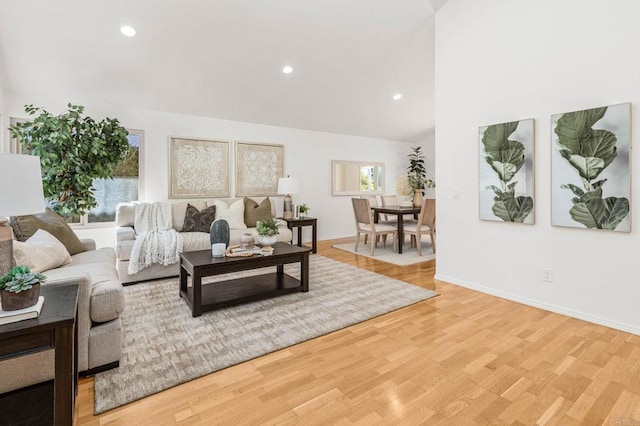 living room featuring light wood-style flooring, recessed lighting, and baseboards