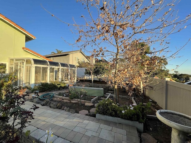 view of patio / terrace featuring a vegetable garden and fence private yard