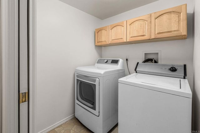 laundry area with washer and dryer, cabinet space, and baseboards