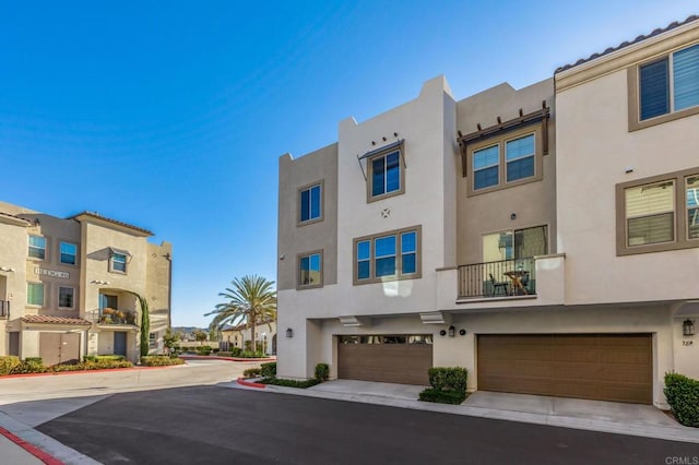 view of building exterior featuring a residential view and an attached garage