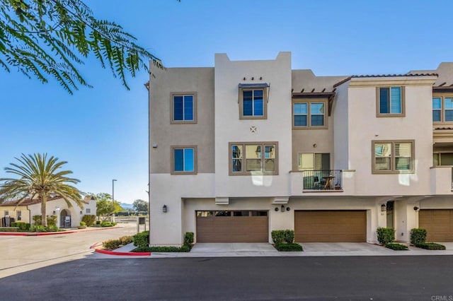 view of front of home with an attached garage and stucco siding