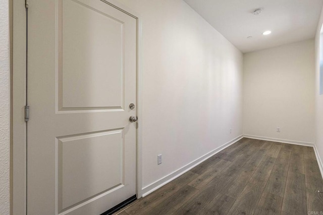 unfurnished room with dark wood-style floors, recessed lighting, and baseboards