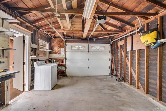 garage with washer / dryer and a garage door opener