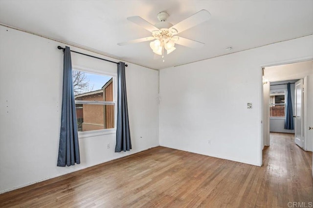 unfurnished room with ceiling fan and wood finished floors