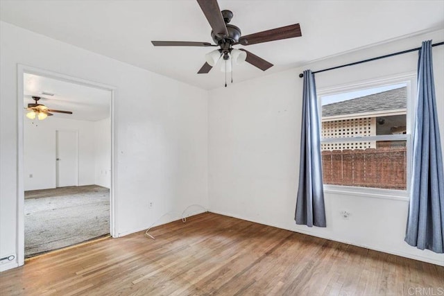 unfurnished room featuring ceiling fan and wood finished floors