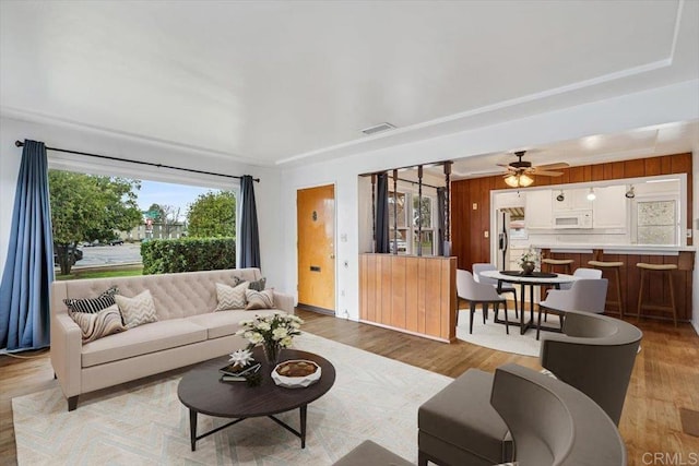 living area with light wood-type flooring and visible vents