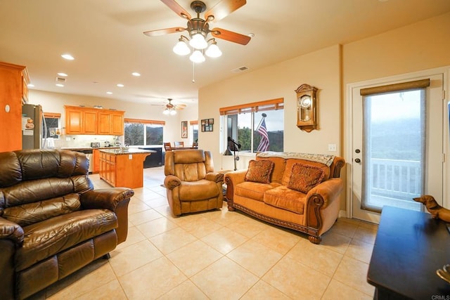 living room with light tile patterned floors, recessed lighting, visible vents, and ceiling fan