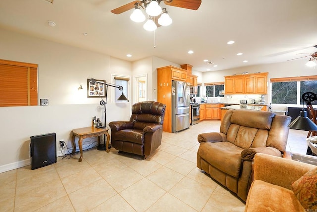 living area with light tile patterned floors, a ceiling fan, and recessed lighting