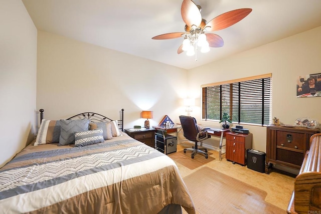 bedroom featuring light colored carpet and ceiling fan