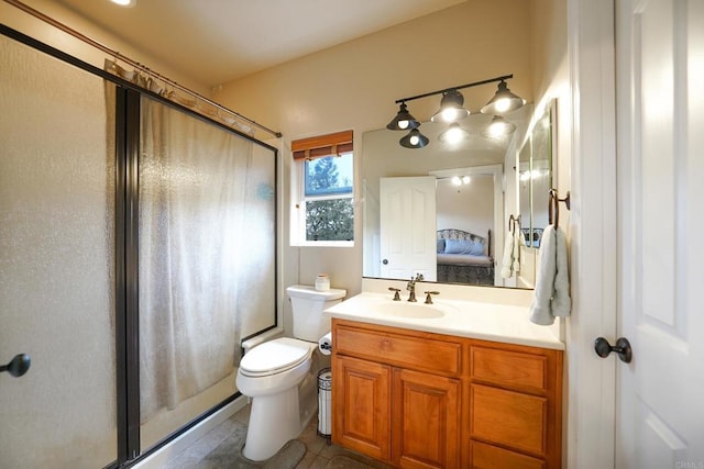 bathroom with tile patterned floors, vanity, toilet, and ensuite bathroom