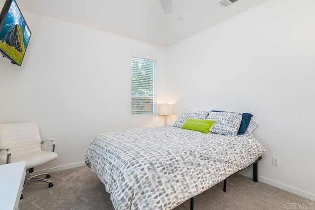 carpeted bedroom featuring baseboards