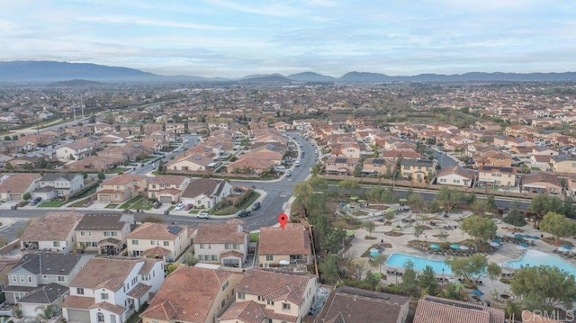 birds eye view of property featuring a mountain view and a residential view