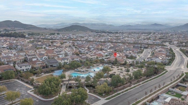 birds eye view of property with a mountain view and a residential view