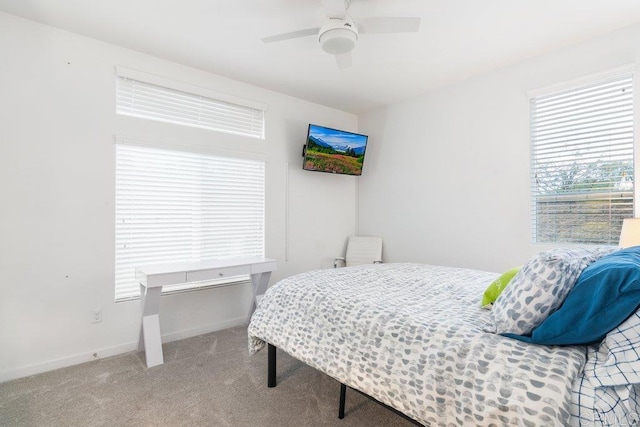 carpeted bedroom with a ceiling fan and baseboards