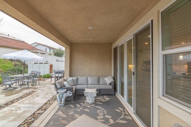 view of patio with outdoor dining space, outdoor lounge area, grilling area, and fence