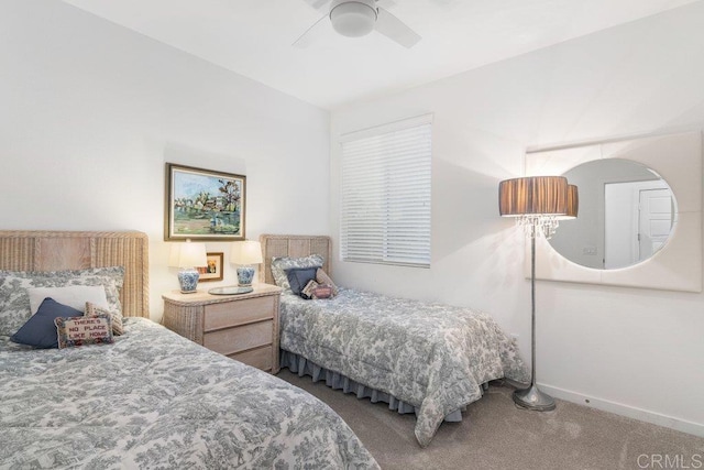 carpeted bedroom featuring ceiling fan and baseboards