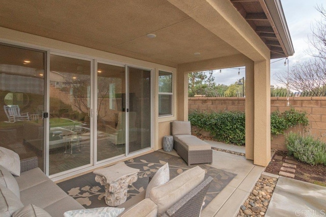 view of patio / terrace featuring outdoor lounge area and fence