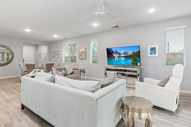 living area featuring recessed lighting, light wood-type flooring, and a healthy amount of sunlight