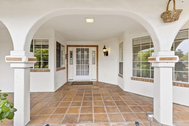 doorway to property featuring stucco siding